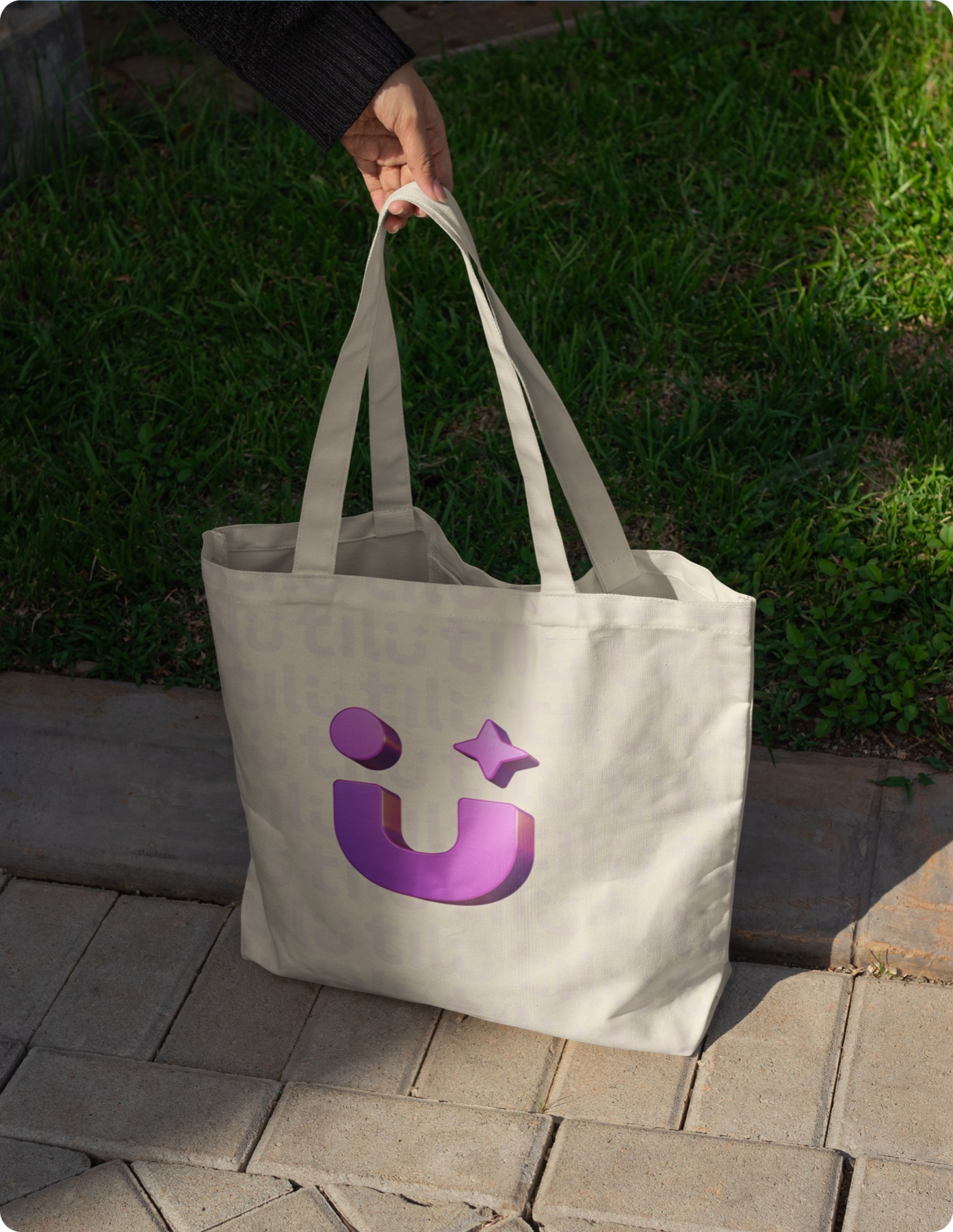 Tilu-branded tote bag held outdoors
